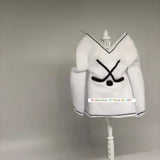 White hockey-themed elf sweater with crossed hockey sticks, displayed on a mannequin stand.