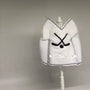 White hockey-themed elf sweater with crossed hockey sticks, displayed on a mannequin stand.