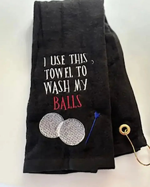 Black personalized golf towel with embroidered golf balls, tee, and humorous text.