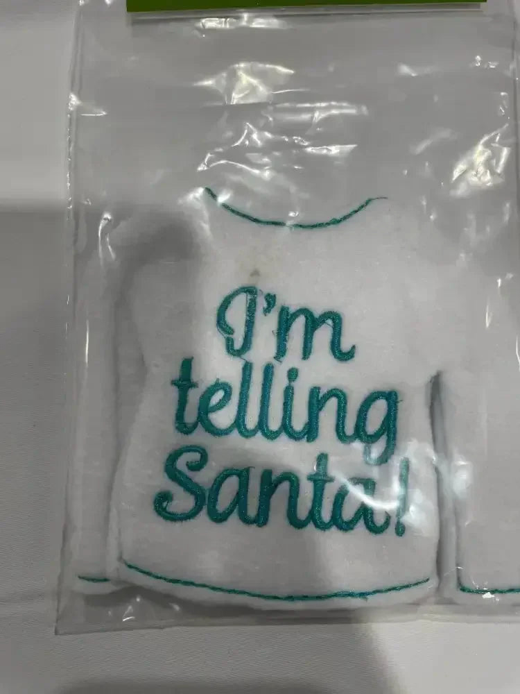 White embroidered elf sweater ornament with 'I'm telling Santa!' in teal text