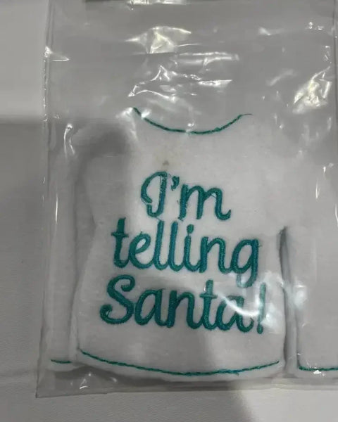 White embroidered elf sweater ornament with 'I'm telling Santa!' in teal text