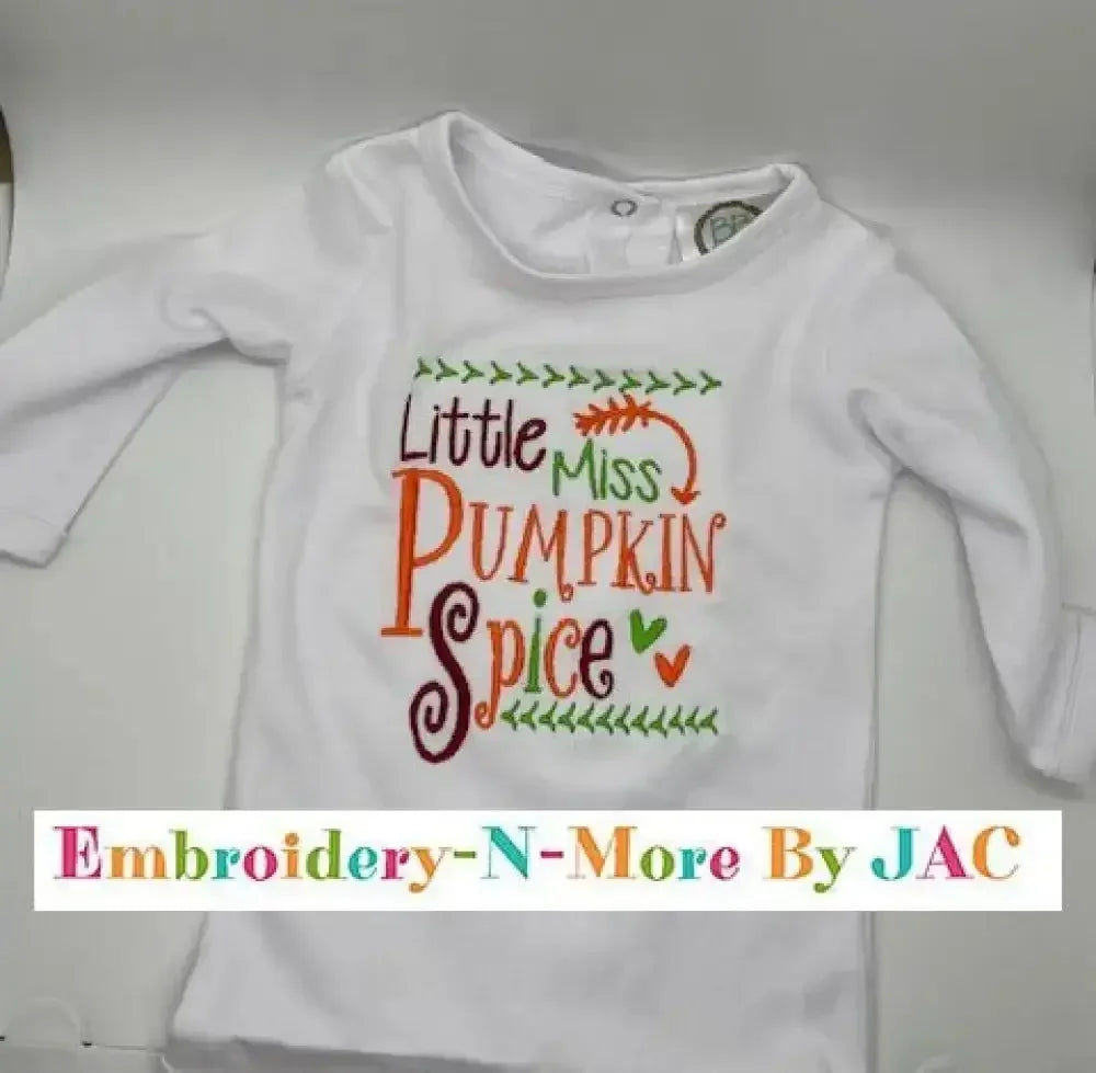 White baby bodysuit with colorful embroidered 'Little Miss Pumpkin Spice' text and leaf accents.