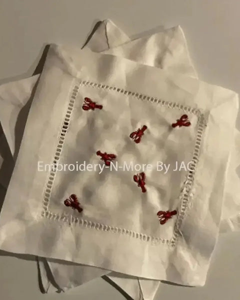 White cocktail napkin set with red lobster embroidery and hemstitch border