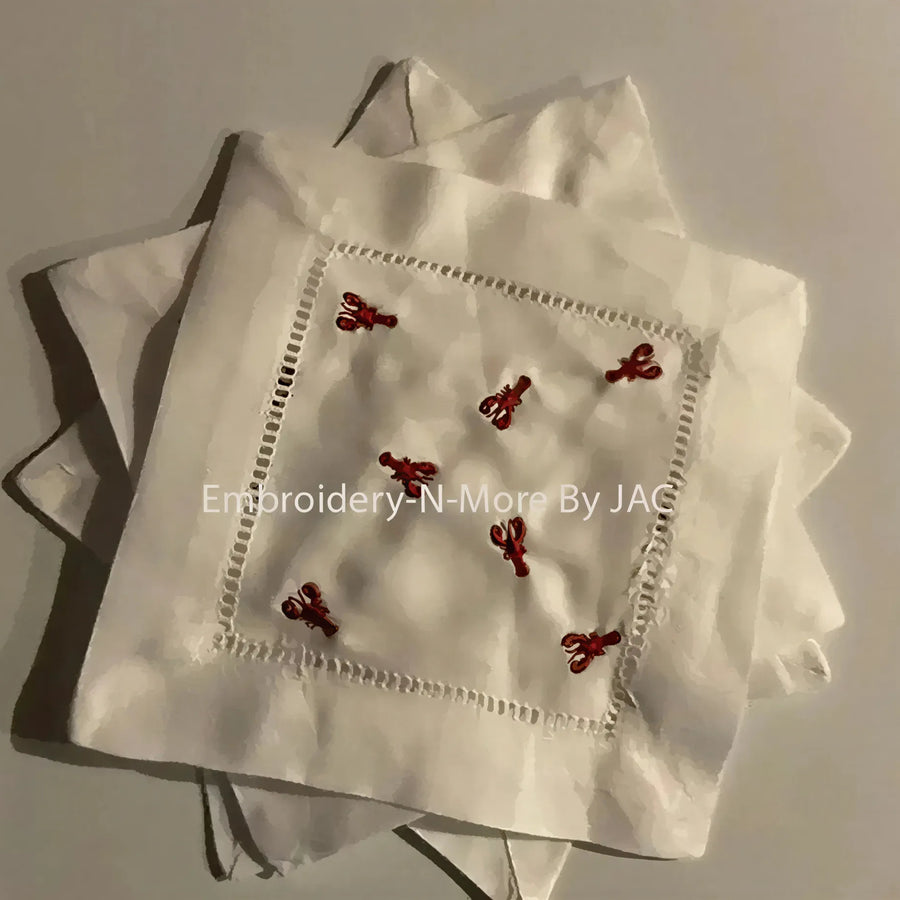 White cocktail napkin set with red lobster embroidery and hemstitch border