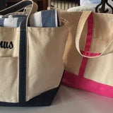 Personalized embroidered tote bags in beige with blue and pink accents, featuring names.