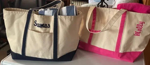 Personalized embroidered tote bags in beige with blue and pink accents, featuring names.