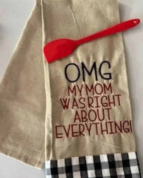 Flour sack towel with embroidered text 'OMG my mom was right about everything' and red spatula