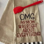 Flour sack towel with embroidered text 'OMG my mom was right about everything' and red spatula