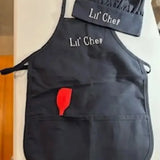 Personalized child apron and chef hat set in black with 'Lil' Chef' embroidery and red spatula