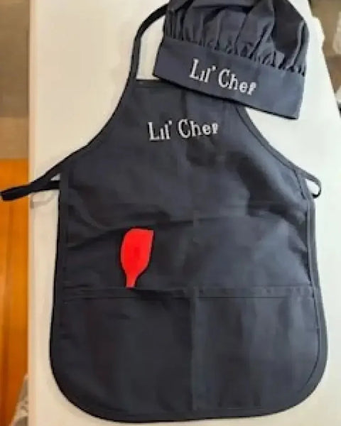 Personalized child apron and chef hat set in black with 'Lil' Chef' embroidery and red spatula