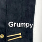 Personalized black golf towel with 'Grumpy' embroidery and two wooden golf tees