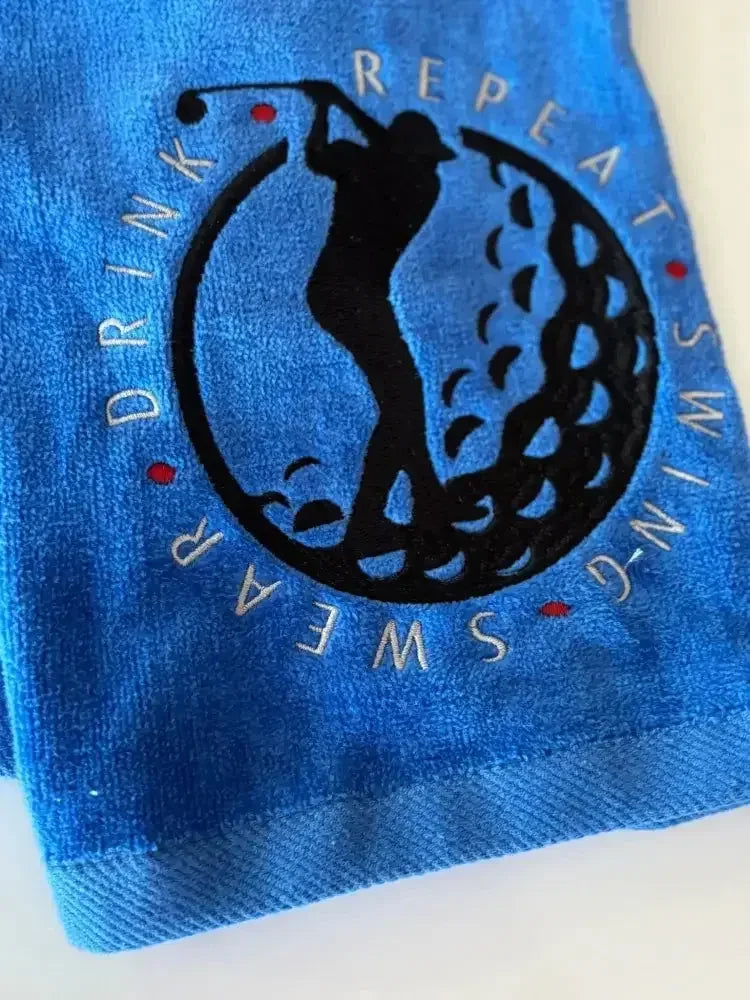 Personalized blue golf towel with embroidered golfer silhouette and 'Swing Swear Drink Repeat' text