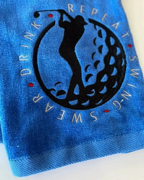 Personalized blue golf towel with embroidered golfer silhouette and 'Swing Swear Drink Repeat' text