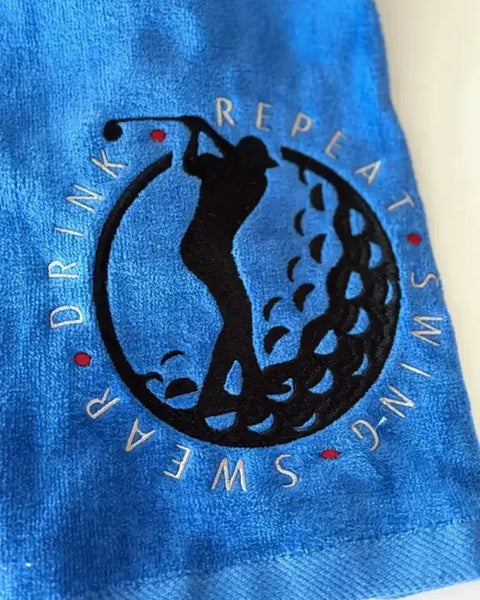 Blue personalized golf towel with embroidered golfer silhouette and Swing Swear Drink Repeat text