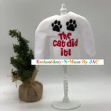 White elf sweater with 'The cat did it!' text, black paw prints, and mini Christmas tree.