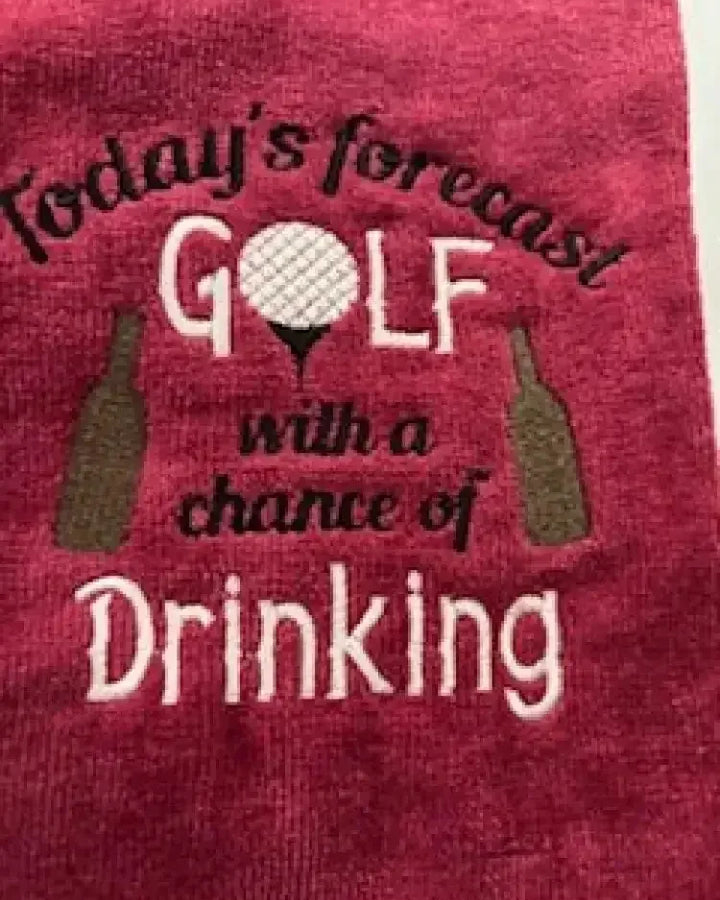 Red embroidered golf towel with humorous saying and golf ball design