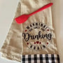 Embroidered kitchen towel with 'Warning! The girls are drinking again' and red spatula