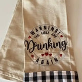 Embroidered kitchen towel with 'Warning! The girls are drinking again' and checkered trim