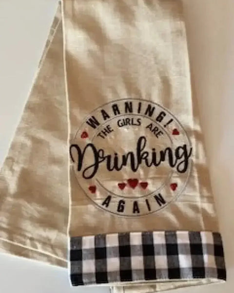 Embroidered kitchen towel with 'Warning! The girls are drinking again' and checkered trim